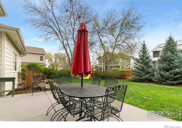 view of patio with fence and outdoor dining space