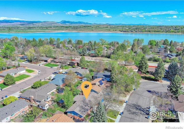 drone / aerial view featuring a residential view and a water and mountain view