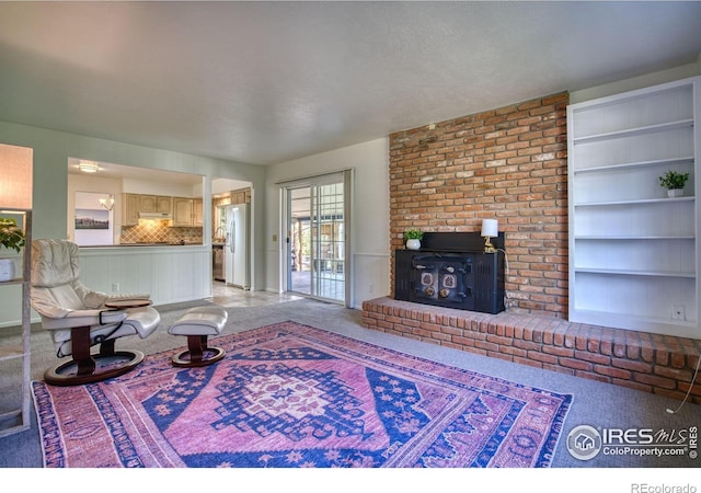 living area with light colored carpet and built in features