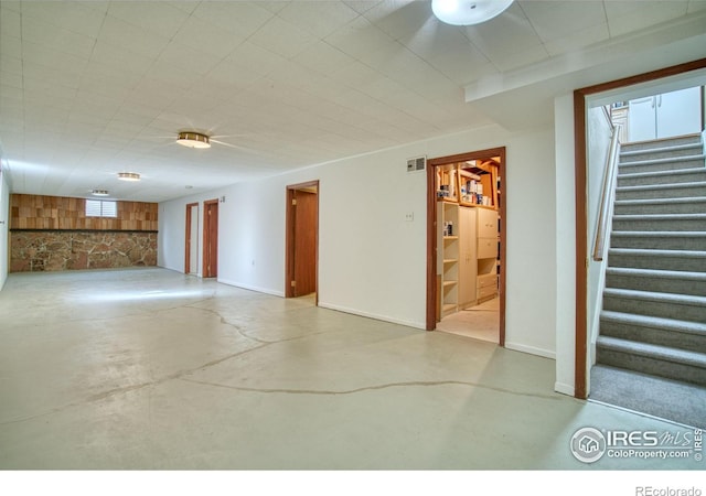 below grade area featuring visible vents, stairs, and baseboards