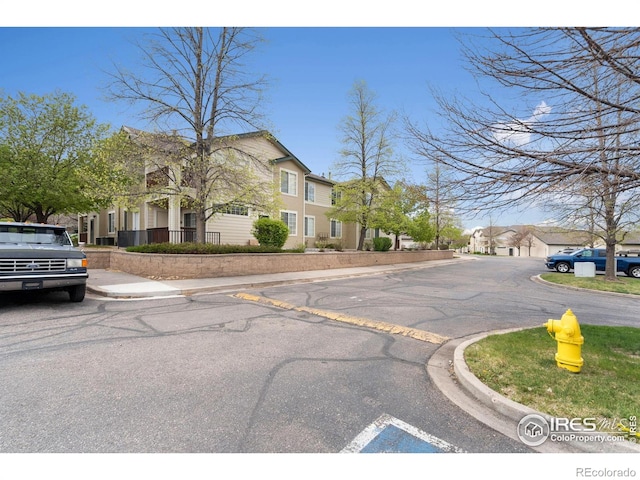 view of street with a residential view and curbs