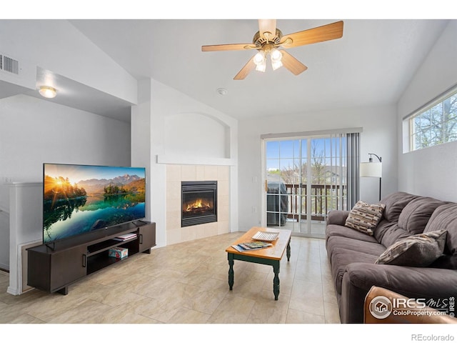 living room featuring a fireplace, a ceiling fan, lofted ceiling, and visible vents