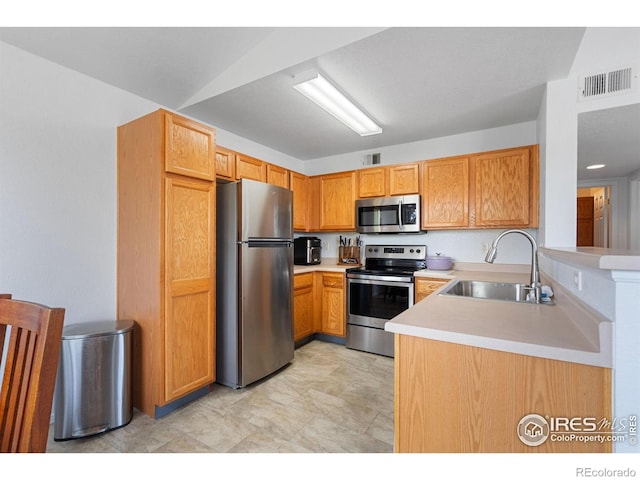 kitchen with visible vents, a sink, light countertops, and stainless steel appliances