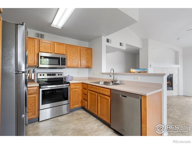 kitchen with a sink, light countertops, stainless steel appliances, and visible vents