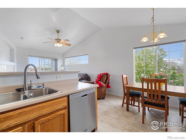 kitchen with a sink, light countertops, decorative light fixtures, stainless steel dishwasher, and vaulted ceiling