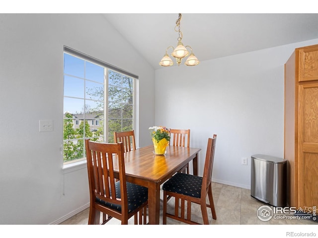 dining area featuring baseboards, an inviting chandelier, and vaulted ceiling