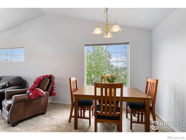 dining space with an inviting chandelier, baseboards, and vaulted ceiling