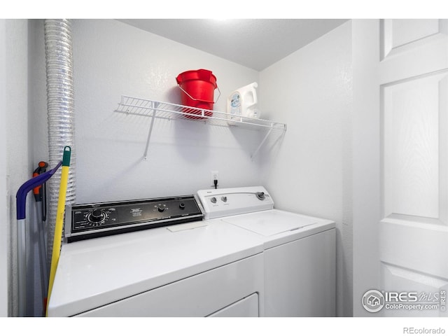 laundry room featuring separate washer and dryer and laundry area