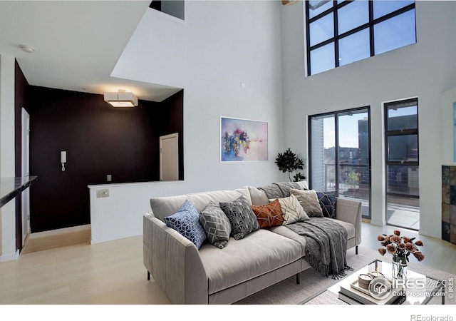 1200 Yarmouth Ave Unit 238, Boulder, CO 80304 - living area with light wood-style flooring, a towering ceiling, and a wealth of natural light