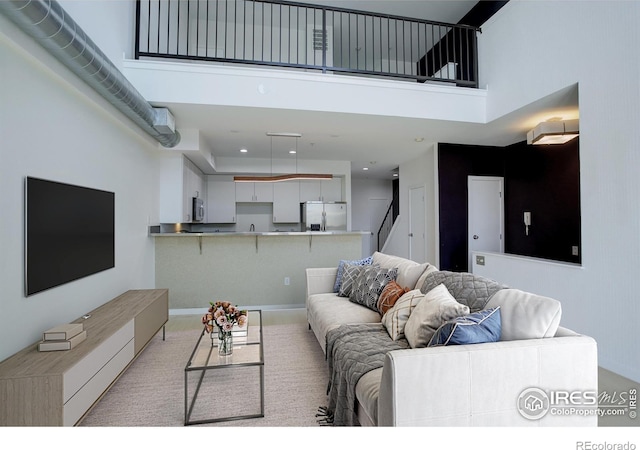 1200 Yarmouth Ave Unit 238, Boulder, CO 80304 - living room with stairway, light carpet, recessed lighting, and a towering ceiling