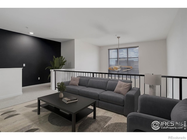carpeted living area featuring recessed lighting and baseboards