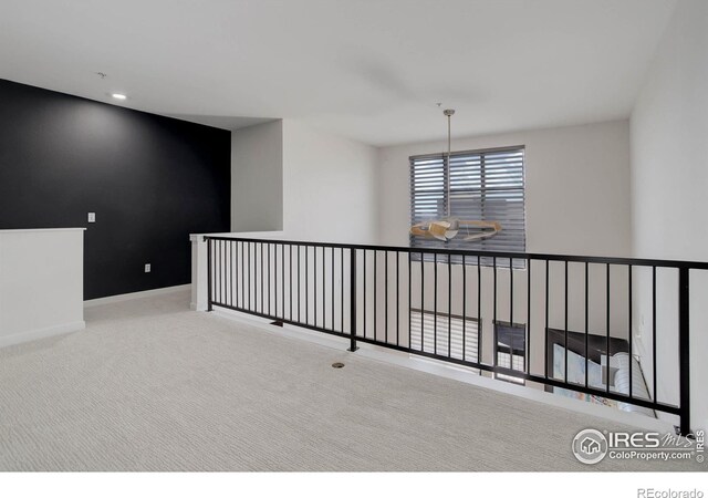 carpeted empty room with baseboards and recessed lighting