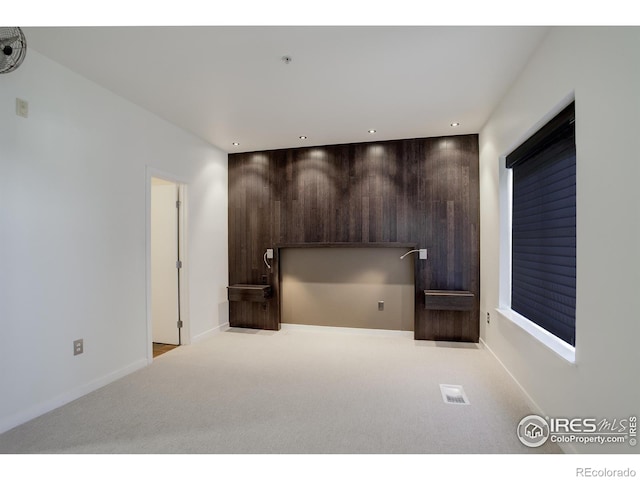 interior space with carpet floors, recessed lighting, and baseboards