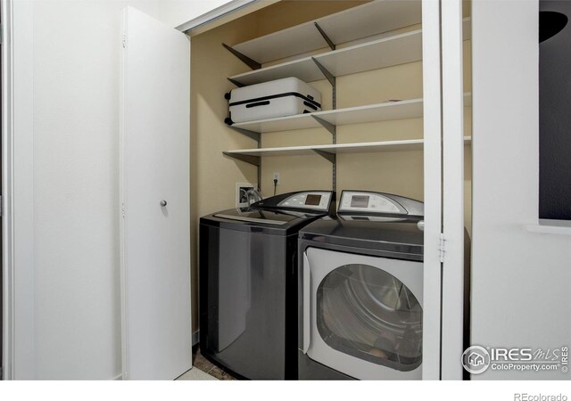 clothes washing area with separate washer and dryer and laundry area