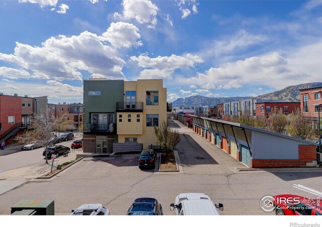 1200 Yarmouth Ave Unit 238, Boulder, CO 80304 - view of building exterior with uncovered parking and a mountain view