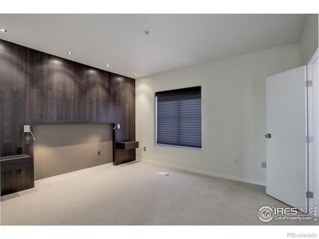 interior space with baseboards, visible vents, recessed lighting, and light colored carpet