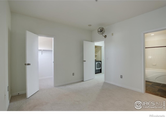 1200 Yarmouth Ave Unit 238, Boulder, CO 80304 - unfurnished bedroom with carpet floors, baseboards, ensuite bathroom, washer / clothes dryer, and a spacious closet