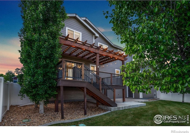672 Dakota Way, Windsor, CO 80550 - back of property at dusk with a pergola, stairs, a wooden deck, and a patio