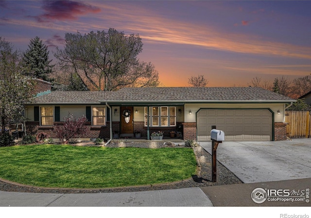 7960 Estes Ct, Arvada, CO 80005 - view of front facade featuring an attached garage, driveway, and brick siding