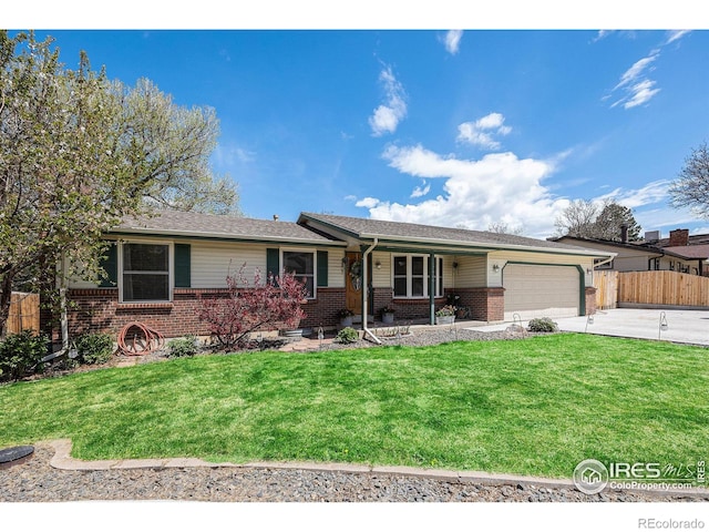 ranch-style house featuring a garage, fence, a front yard, brick siding, and concrete driveway