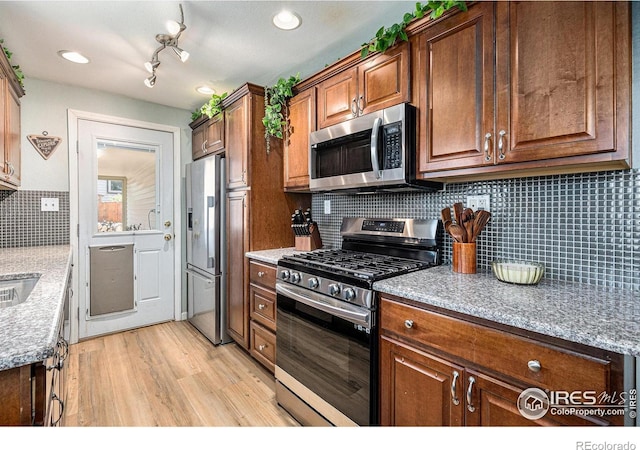 7960 Estes Ct, Arvada, CO 80005 - kitchen featuring tasteful backsplash, stainless steel appliances, recessed lighting, and light wood-style flooring
