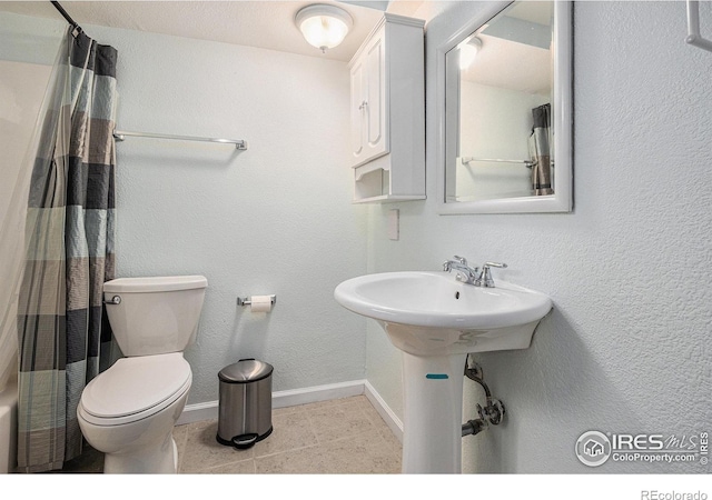 7960 Estes Ct, Arvada, CO 80005 - bathroom with toilet, baseboards, curtained shower, and tile patterned flooring