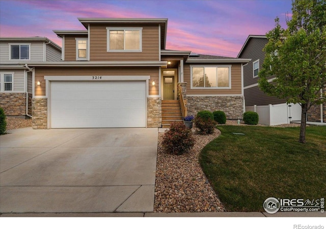 view of front of house with fence, a front lawn, stone siding, a garage, and concrete driveway