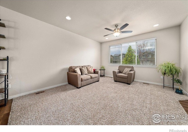carpeted living area featuring baseboards, recessed lighting, ceiling fan, and visible vents
