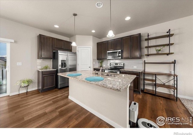 kitchen with dark brown cabinetry, appliances with stainless steel finishes, tasteful backsplash, dark wood finished floors, and baseboards