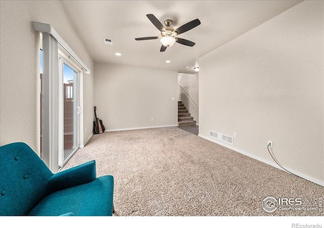 unfurnished room featuring ceiling fan, carpet floors, stairs, baseboards, and visible vents
