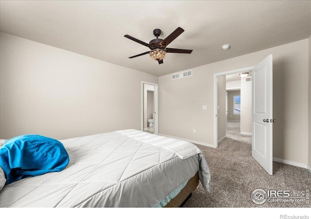 carpeted bedroom with visible vents, baseboards, and ceiling fan