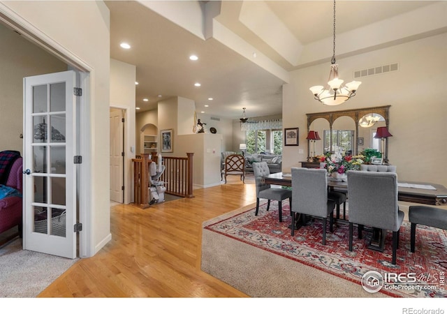 6836 Spanish Bay Dr, Windsor, CO 80550 - dining space featuring visible vents, arched walkways, a notable chandelier, recessed lighting, and light wood-style flooring