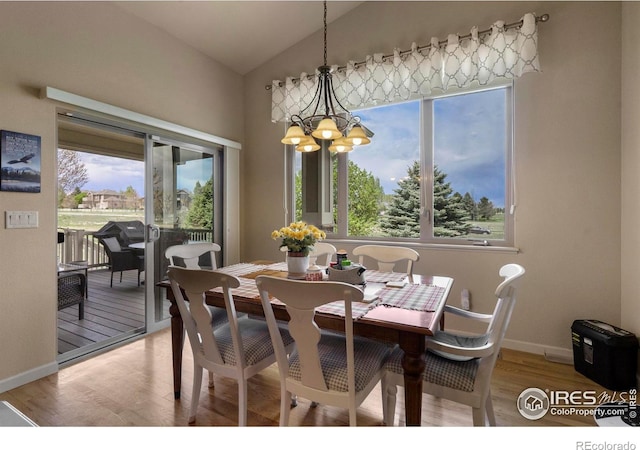 6836 Spanish Bay Dr, Windsor, CO 80550 - dining space with a chandelier, a wealth of natural light, light wood-style flooring, and vaulted ceiling