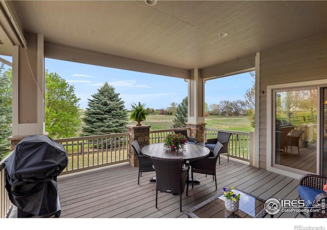 6836 Spanish Bay Dr, Windsor, CO 80550 - wooden deck featuring grilling area and outdoor dining space