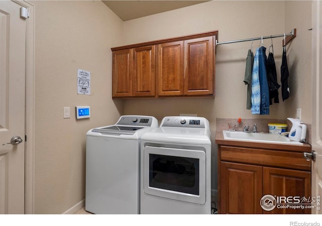 6836 Spanish Bay Dr, Windsor, CO 80550 - laundry area with a sink, cabinet space, and washer and clothes dryer