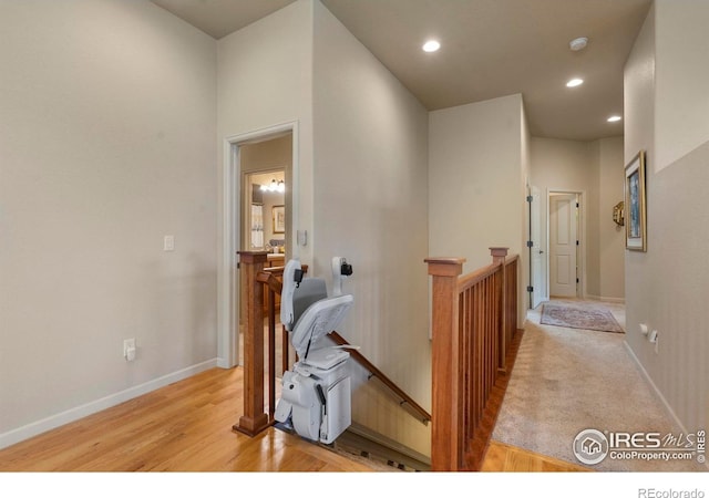 6836 Spanish Bay Dr, Windsor, CO 80550 - hallway featuring baseboards, recessed lighting, light wood-style flooring, and an upstairs landing
