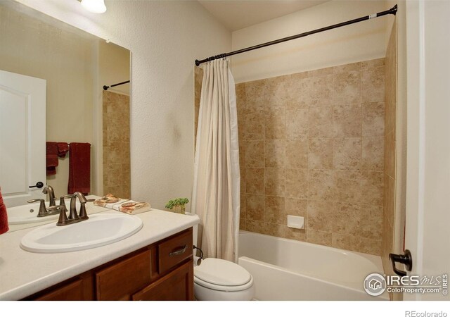 full bathroom with vanity, toilet, and shower / tub combo with curtain