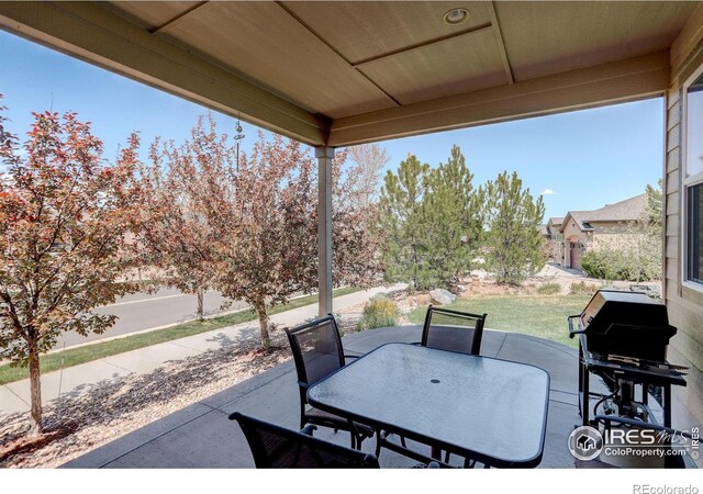 view of patio featuring outdoor dining area, fence, and grilling area
