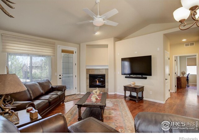 living area featuring a ceiling fan, vaulted ceiling, a wealth of natural light, and visible vents
