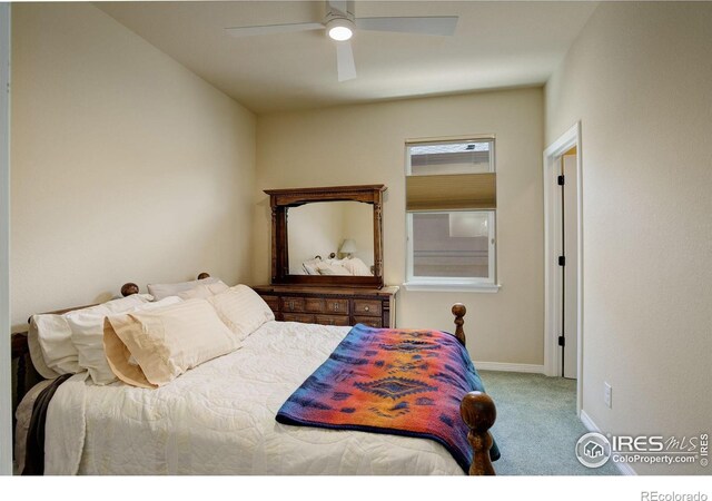 carpeted bedroom featuring baseboards and ceiling fan