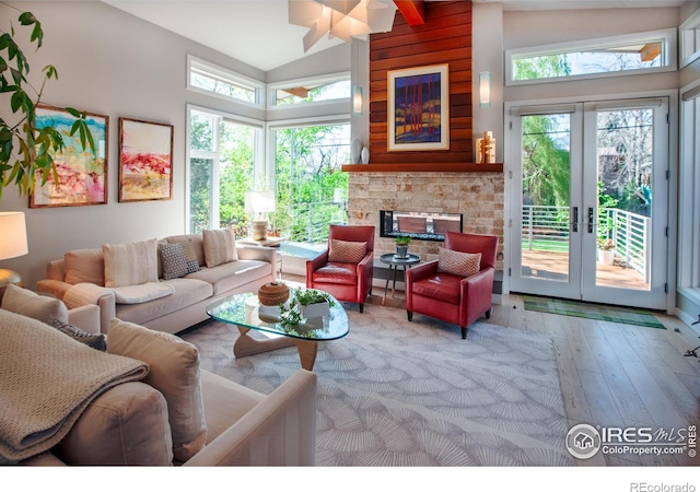 560 Iris Ave, Boulder, CO 80304 - living area with high vaulted ceiling, wood-type flooring, plenty of natural light, french doors, and a multi sided fireplace