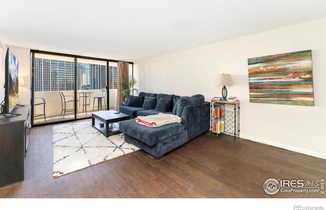 living room featuring baseboards and wood finished floors