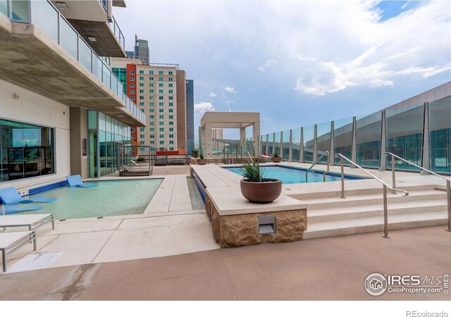 pool featuring a patio and fence