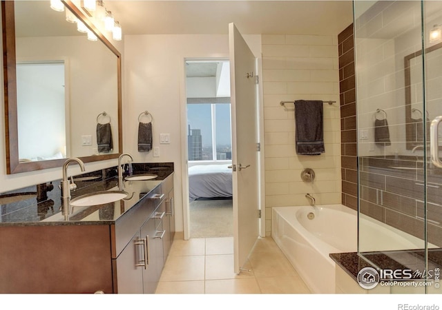bathroom featuring connected bathroom, tile patterned floors, a sink, and a shower