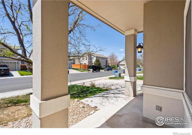 view of patio featuring a residential view and a porch