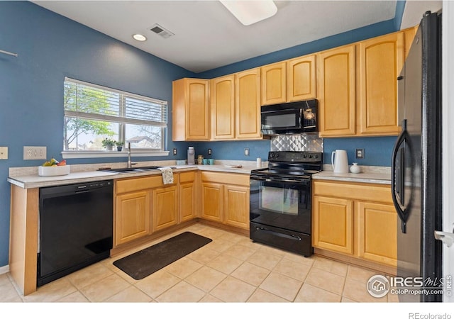 kitchen featuring a sink, black appliances, and light brown cabinets