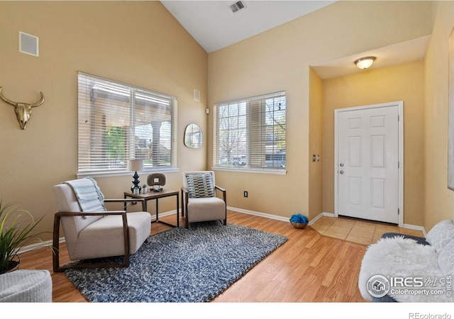 sitting room featuring visible vents, a healthy amount of sunlight, and wood finished floors