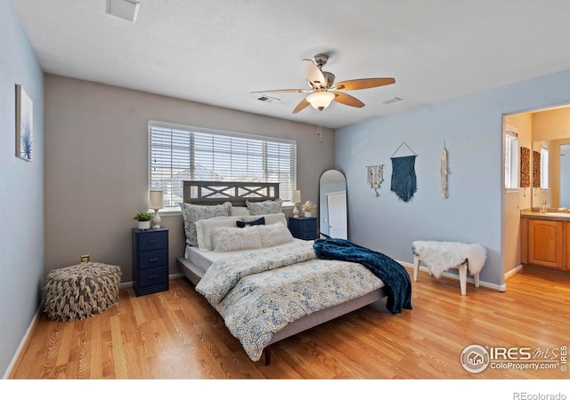 bedroom with a ceiling fan, baseboards, visible vents, and light wood-style flooring