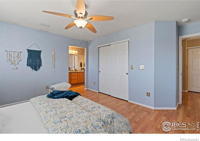 bedroom featuring ceiling fan, light wood finished floors, baseboards, visible vents, and a closet