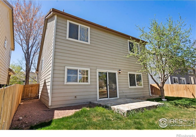 rear view of house featuring a patio and a fenced backyard